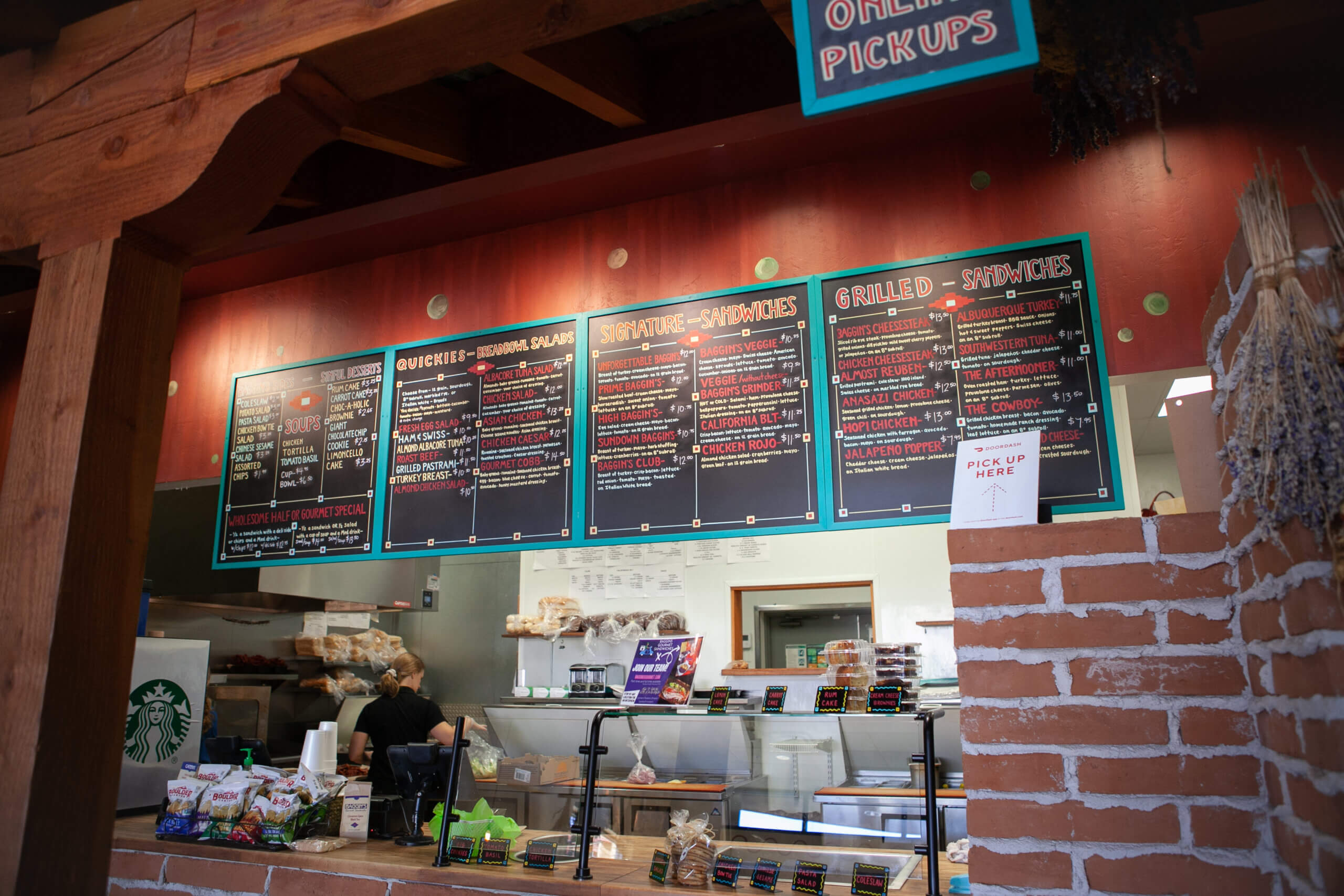 The menu boards hanging over the counter at Baggin's Gourmet Sandwiches in Tucson